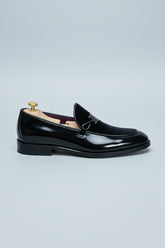 Black velvet loafer with elegant buckle, perfect for formal events and weddings.